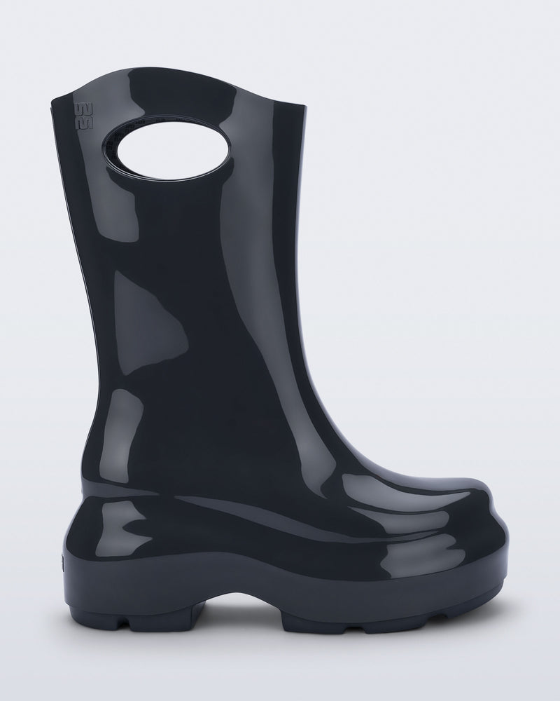 Side view of a grey Ultra platform rain Boot with circle cutout on top