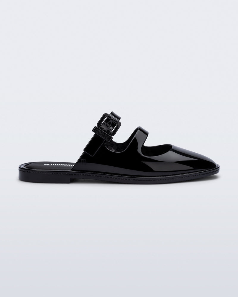 Side view of a black Anastasia mule slide with upper straps
