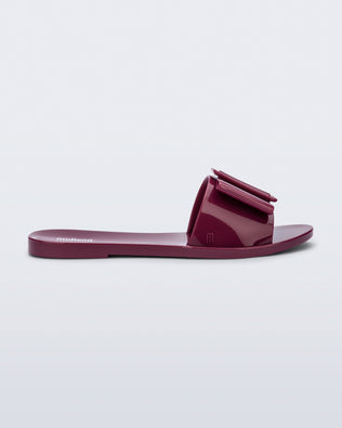Side view of a burgundy Babe slide sandal