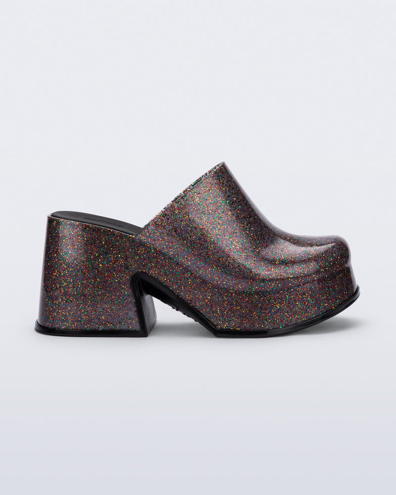 Side view of a mixed glitter Mia mule with black sole