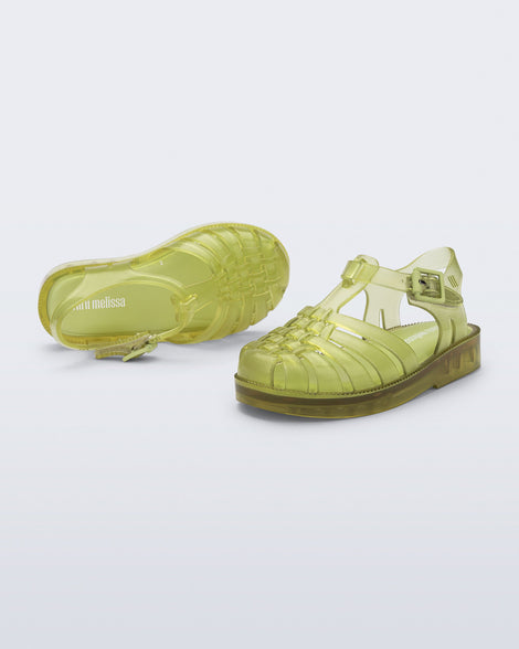 Top and angled view of a pair of transparent green Possession fisherman baby sandals