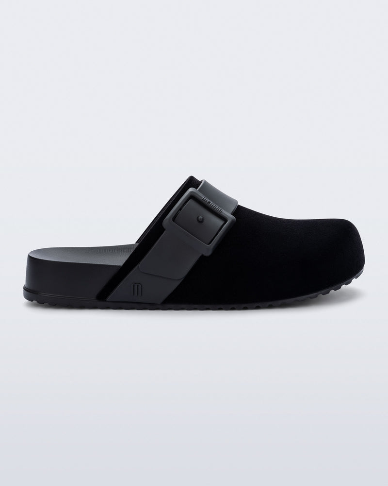 Side view of a black Cozy Clog Velvet slides