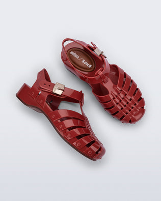 Side and top view of a pair of red Possession Pescura + Scholl fisherman sandals