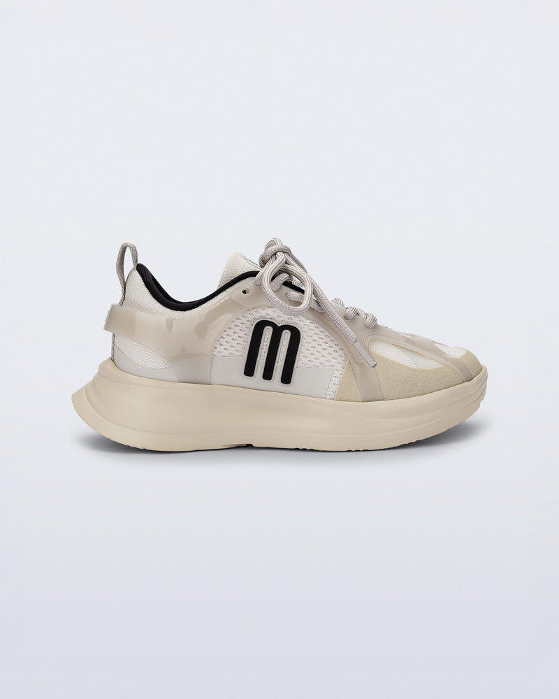 Side view of an off white X Beat kids sneaker with black trim