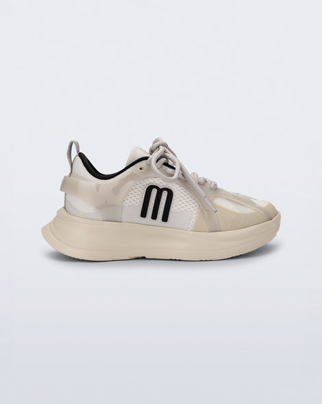 Side view of an off white X Beat kids sneaker with black trim
