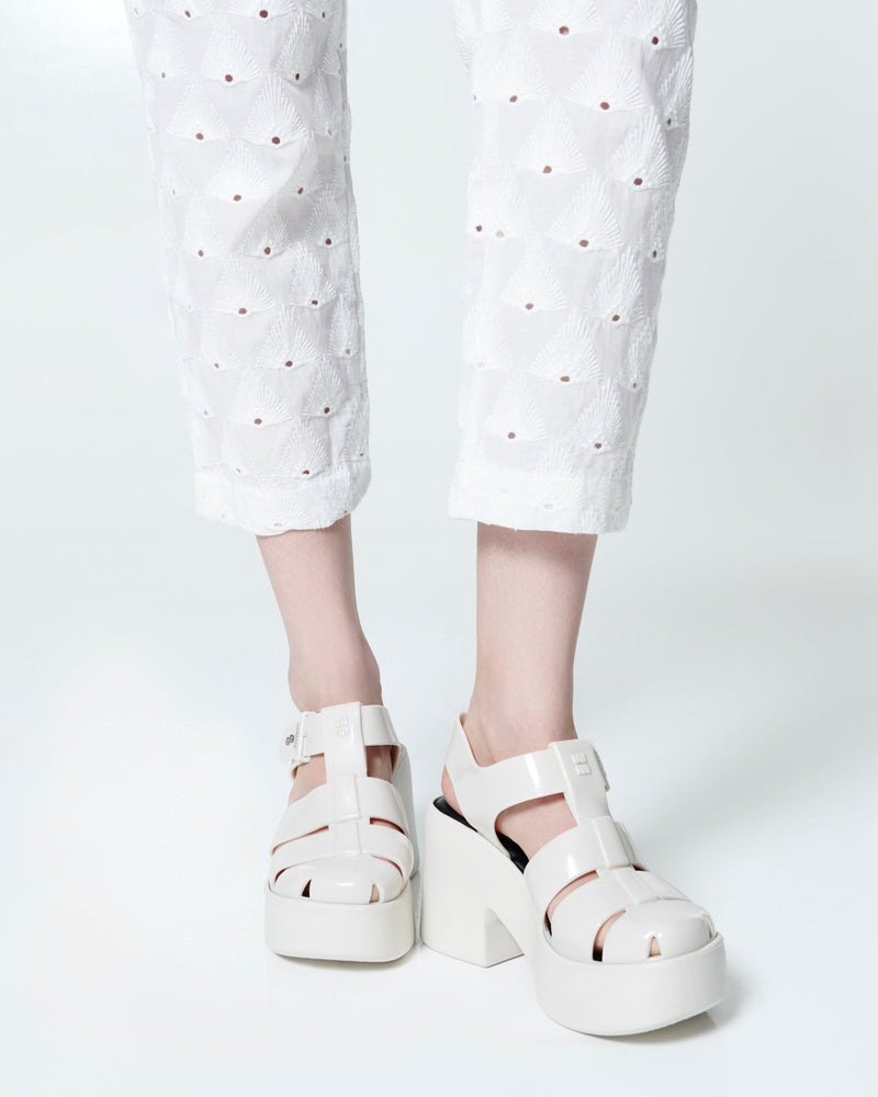 Model's legs in a pair of beige Lulu platform heel fisherman sandals