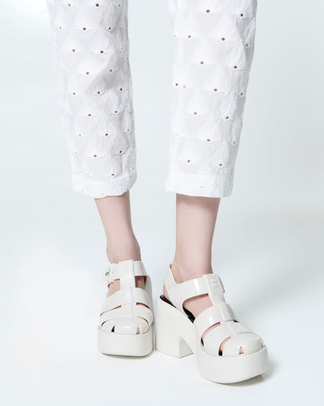 Model's legs in a pair of beige Lulu platform heel fisherman sandals