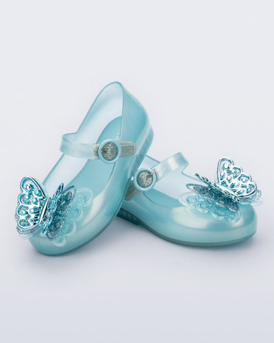 Angled view of a pair of blue Sweet Love Butterfly baby flats