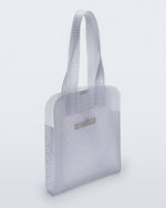 Angled view of a clear Harper bag with shoulder straps
