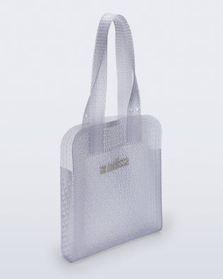 Angled view of a clear Harper bag with shoulder straps