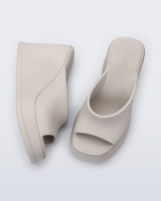 Top and side view of a pair of beige Free Slip platform wedge heels