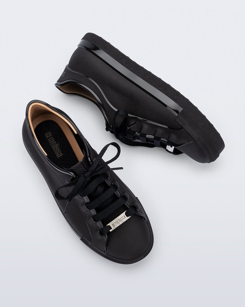 Top and side view of a pair of black Wow Sneakers with black laces
