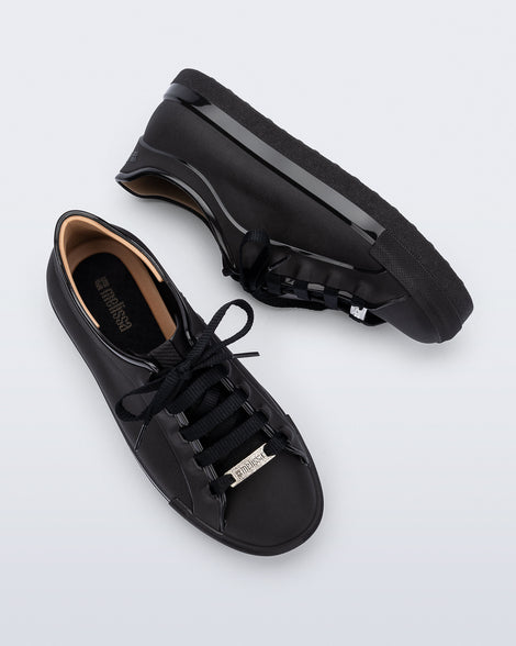Top and side view of a pair of black Wow Sneakers with black laces