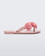 Side view of a pink Harmonic Springtime kids flip flop with three pink flowers.