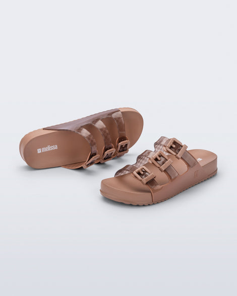 Top and angled view of a pair of brown Cozy Stripes sandals with transparent brown upper with 3 buckles