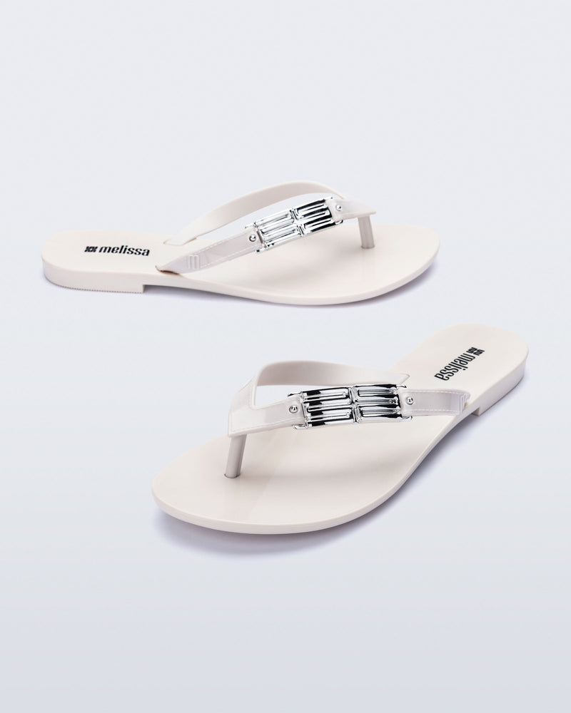 Side and angled view of a pair of white Harmonic M Chic
