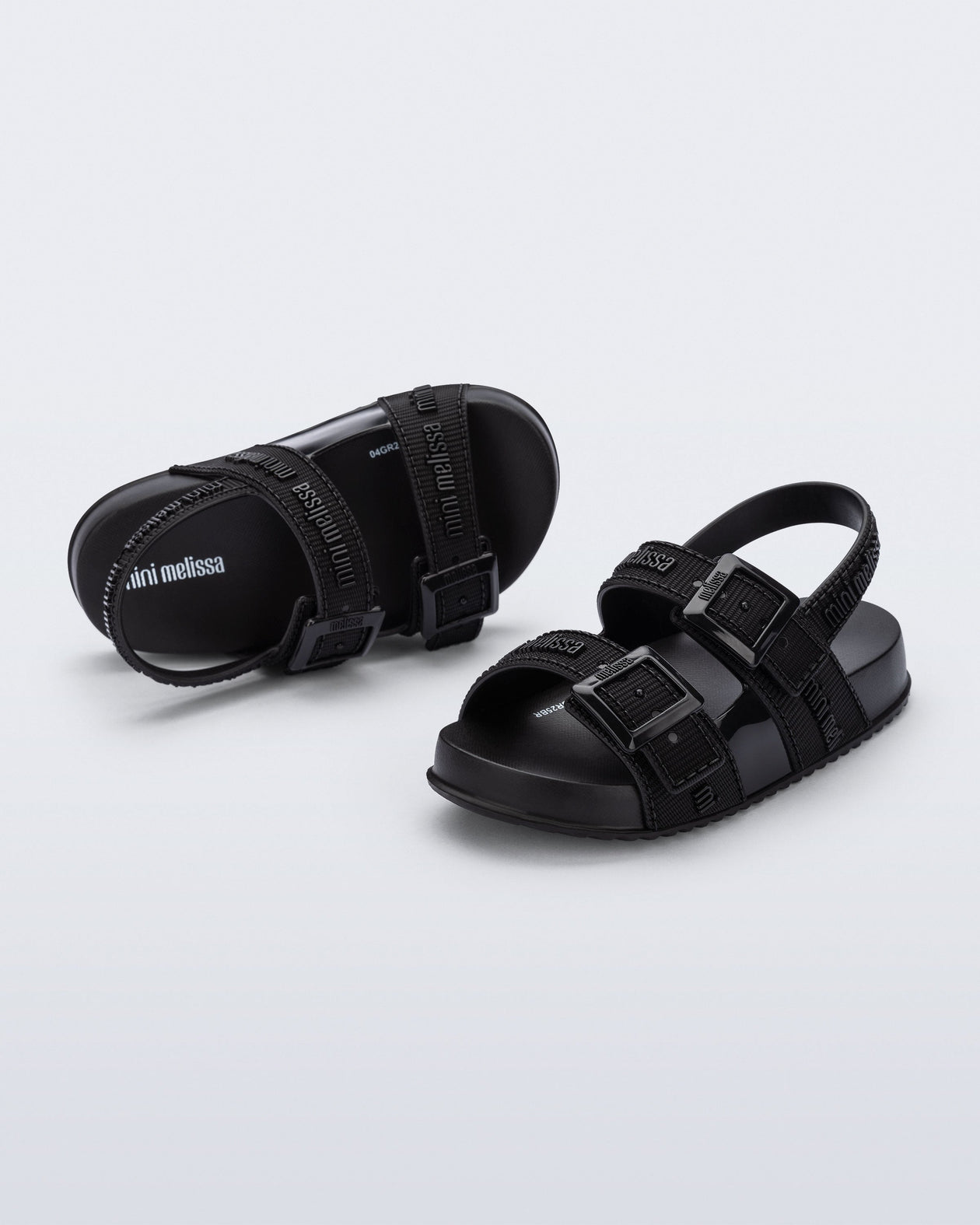 Top and angled view of a pair of black Cozy M Lover baby sandals