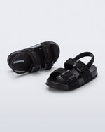 Top and angled view of a pair of black Cozy M Lover baby sandals