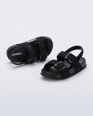 Top and angled view of a pair of black Cozy M Lover baby sandals