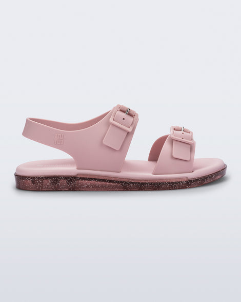 Side  view of a pink Wave Sandal with two straps with buckles and a back strap