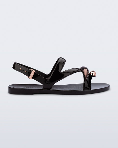Side view of an black  Iris sandal with copper upper embellishments