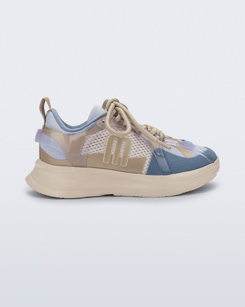 Side view of a blue X Beat kids sneaker with beige trim