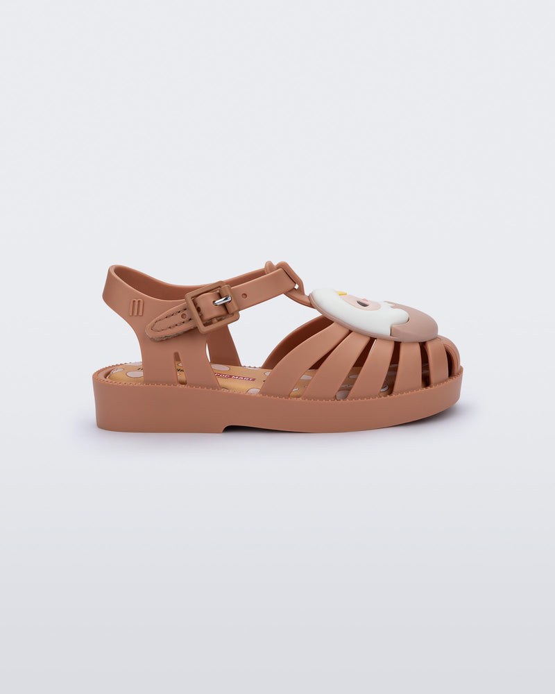 Side view of a beige Possession + Pop Mart Pucky fisherman baby sandal