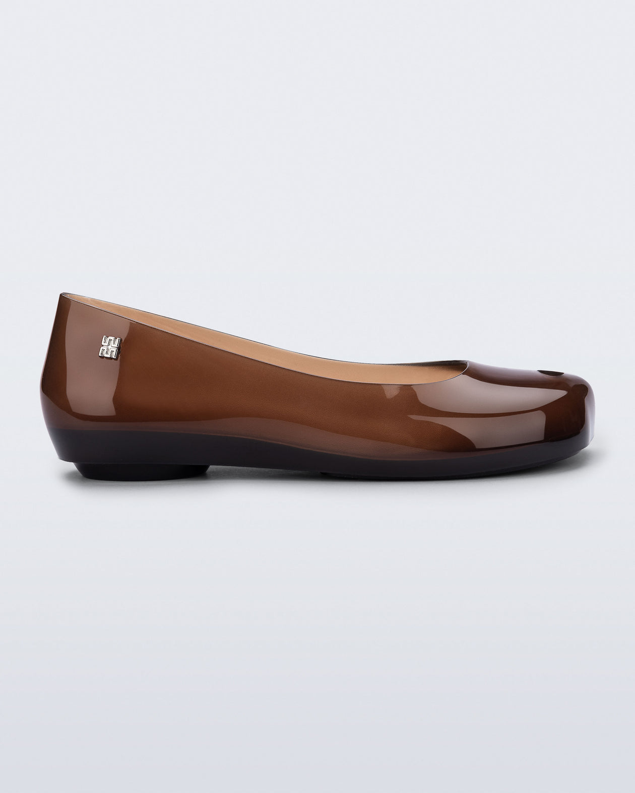 Side view of a clear brown Ultragirl Futura flat