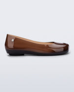 Side view of a clear brown Ultragirl Futura flat