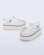 Back and angled view of a pair of clear Possession Platform kids fisherman sandals with white soles