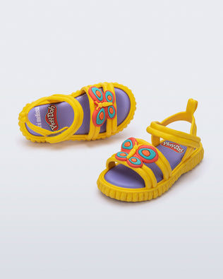Top and angled view of a pair of yellow Create + Play Doh sandal with Butterfly