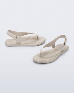 Side and angled view of a pair of beige Sun Samba thong sandals