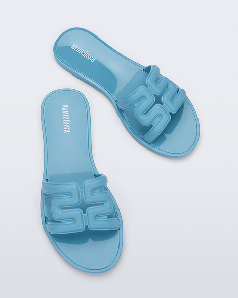 Top view of a pair of blue M Slide sandals