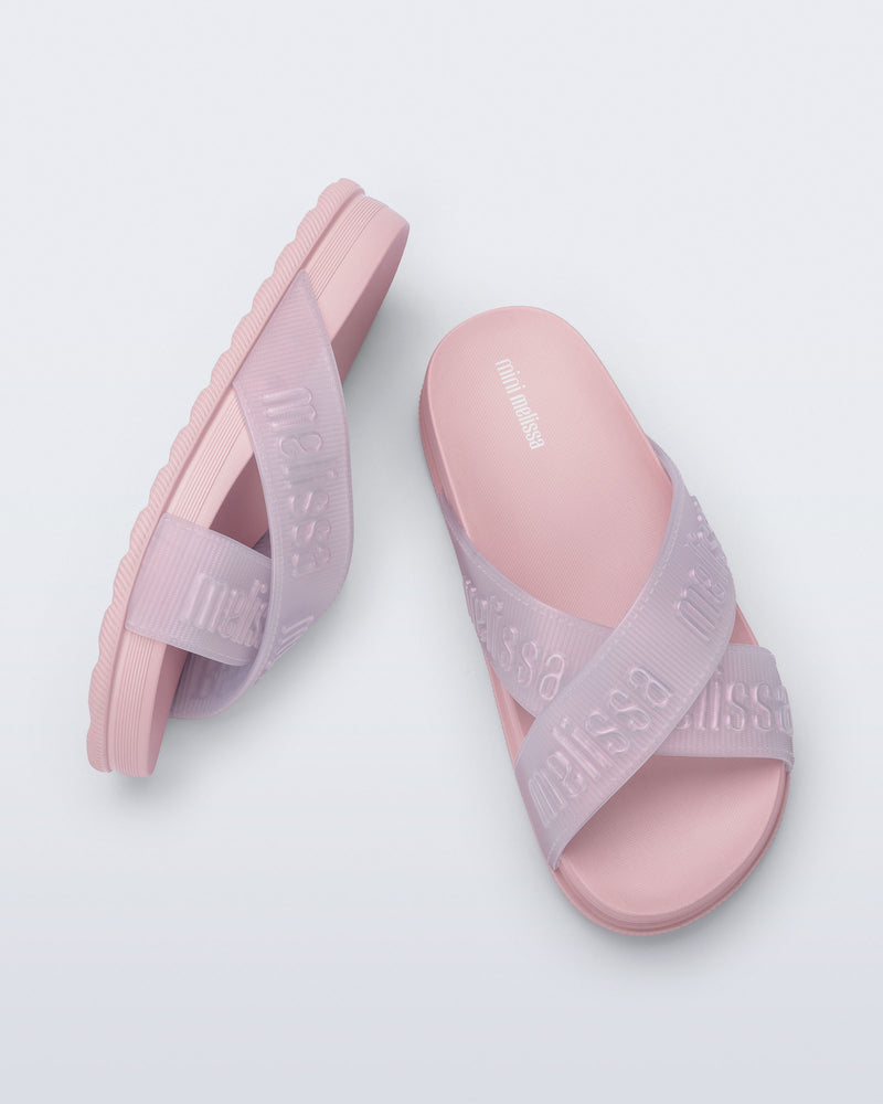 Side and top view of a pair of light pink Cozy M Lover Slides with Melissa on the upper