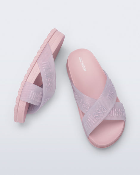 Side and top view of a pair of light pink Cozy M Lover Slides with Melissa on the upper