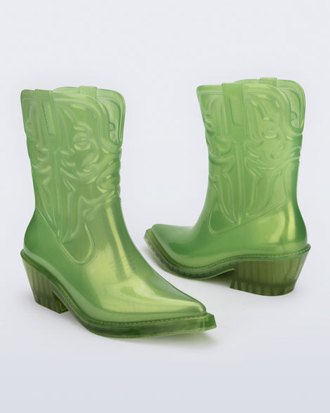 Angled view of a pair of pearly green Texas boots with pointed toe.