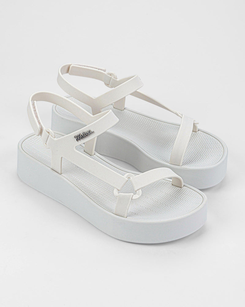 Angled view of a pair of white Sun Downtown Platform sandals