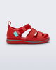 Side view of a red Smash closed toe baby sandal with blue trim