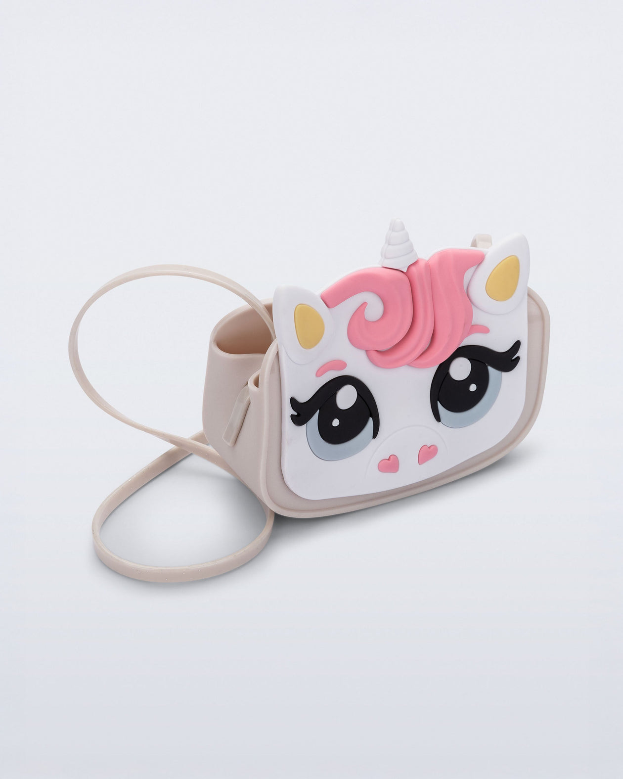 Angled view of a beige Dreamy Unicorn kids bag with a unicorn face on front with pink hair