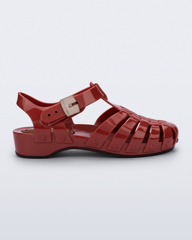 Side view of a red Possession Pescura + Scholl fisherman sandal with white bottom sole