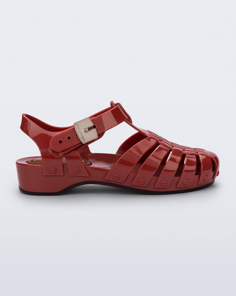 Side view of a red Possession Pescura + Scholl fisherman sandal with white bottom sole