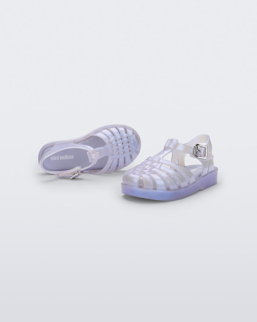 A top and front view of a pair of pearly blue Mini Melissa Possession sandals with a fisherman sandal design