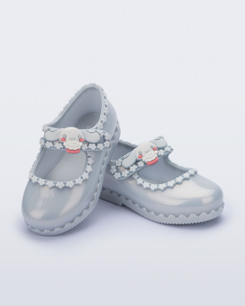 Angled view of a pair of pearly blue Hip Ballerina + Hello Kitty baby flats