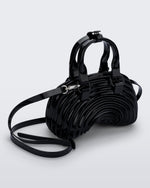 Angled view of a black Quantum Dome + Diesel bag with hand strap and shoulder strap