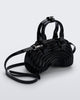 Angled view of a black Quantum Dome + Diesel bag with hand strap and shoulder strap