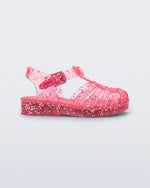 Side view of a pink Possession Elements baby sandal with glitter hearts