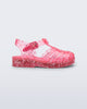 Side view of a pink Possession Elements baby sandal with glitter hearts