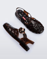 Top view of a pair of clear brown Possession + Pop Mart Pucky fisherman sandals