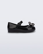 Side view of a black Sweet Love Glam baby ballerina with bow