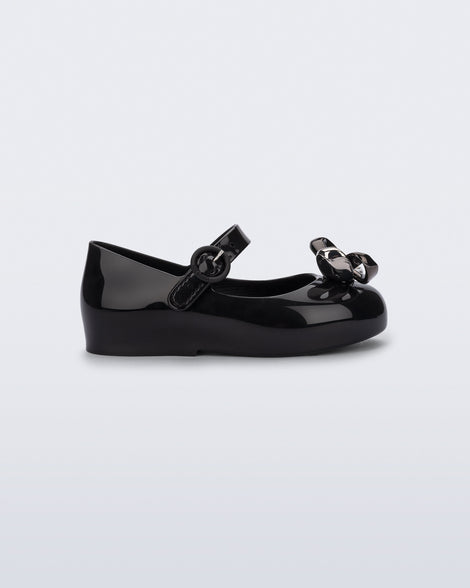 Side view of a black Sweet Love Glam baby ballerina with bow